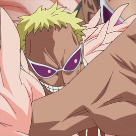 An image of DonQuixote Doflamingo from the One Piece anime. He is grinning menancingly, and part of his wrist and hand are in the foreground.